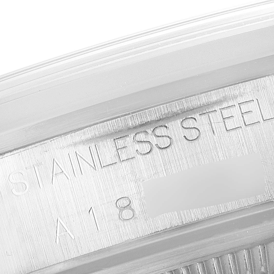 The image shows a close-up of the stainless steel engraving on the case rim of a Rolex Date 15200 Men's Stainless Steel Pink Dial 15200 Men's Stainless Steel Pink Dial model watch.