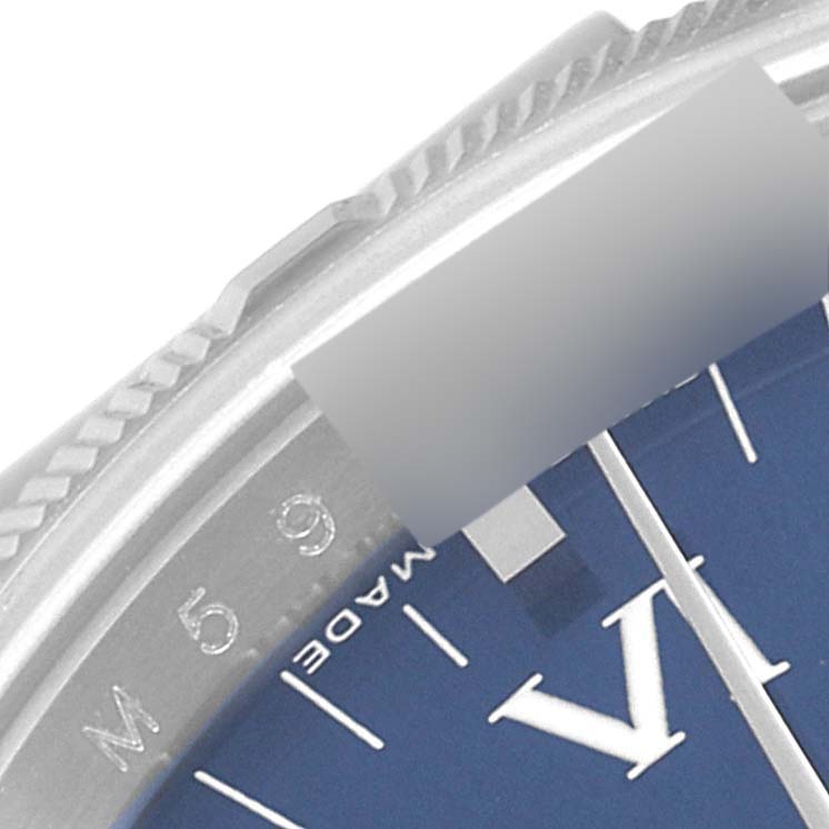 This close-up shows a portion of the blue dial and serrated bezel edge of a Rolex Air-King 114210 Men's Stainless Steel Blue Dial 114210 Men's Stainless Steel Blue Dial watch.