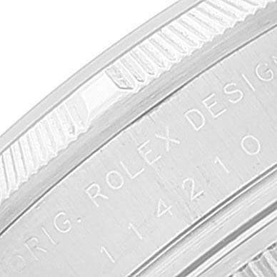 The image shows a close-up of the side of a Rolex Air-King 114210 Men's Stainless Steel Blue Dial 114210 Men's Stainless Steel Blue Dial watch case, displaying the model number and "ORIG. ROLEX DESIGN" engraving.