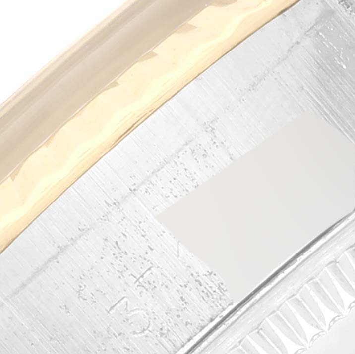 The image shows a close-up of the bezel and part of the case of a Rolex Date 6917 Women's Steel and Gold (two tone) Champagne Dial 6917 Women's Steel and Gold (two tone) Champagne Dial watch.