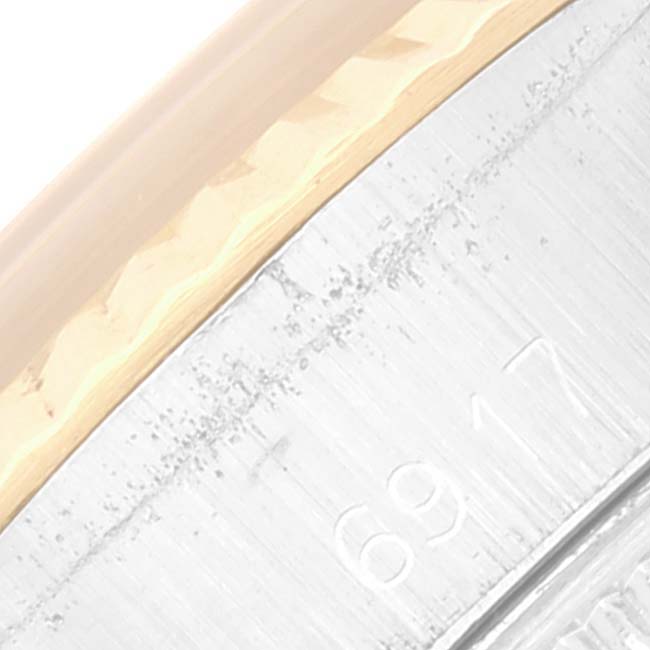 This image shows a close-up of the bezel and part of the casing of a Rolex Date 6917 Women's Steel and Gold (two tone) Champagne Dial 6917 Women's Steel and Gold (two tone) Champagne Dial watch model.