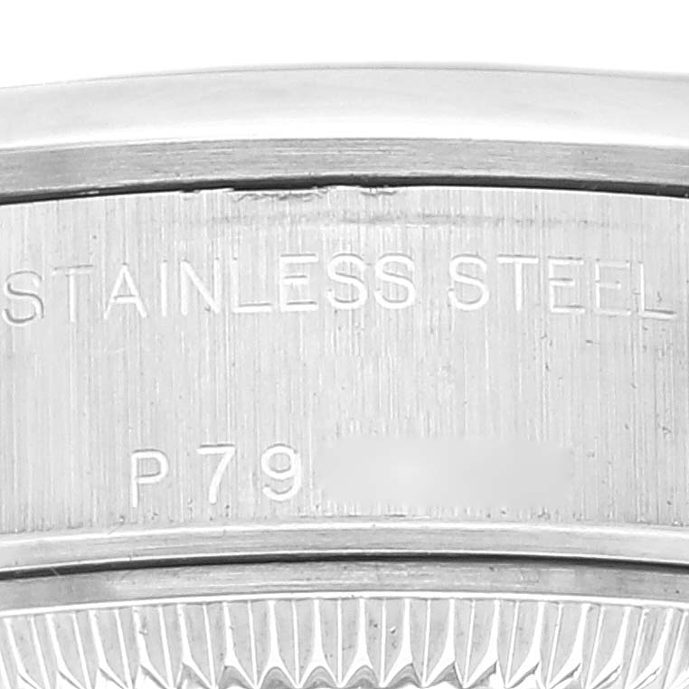 This image shows a close-up of the stainless steel back case of a Rolex Date 79160 Women
s Stainless Steel White Dial 79160 Women
s Stainless Steel White Dial model watch.