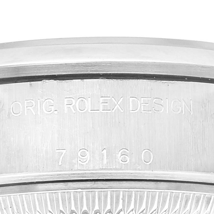 The image shows a close-up of the case back of a Rolex Date 79160 Women
s Stainless Steel White Dial 79160 Women
s Stainless Steel White Dial model watch, highlighting the model number 79160 and the engraved "ORIG. ROLEX DESIGN."