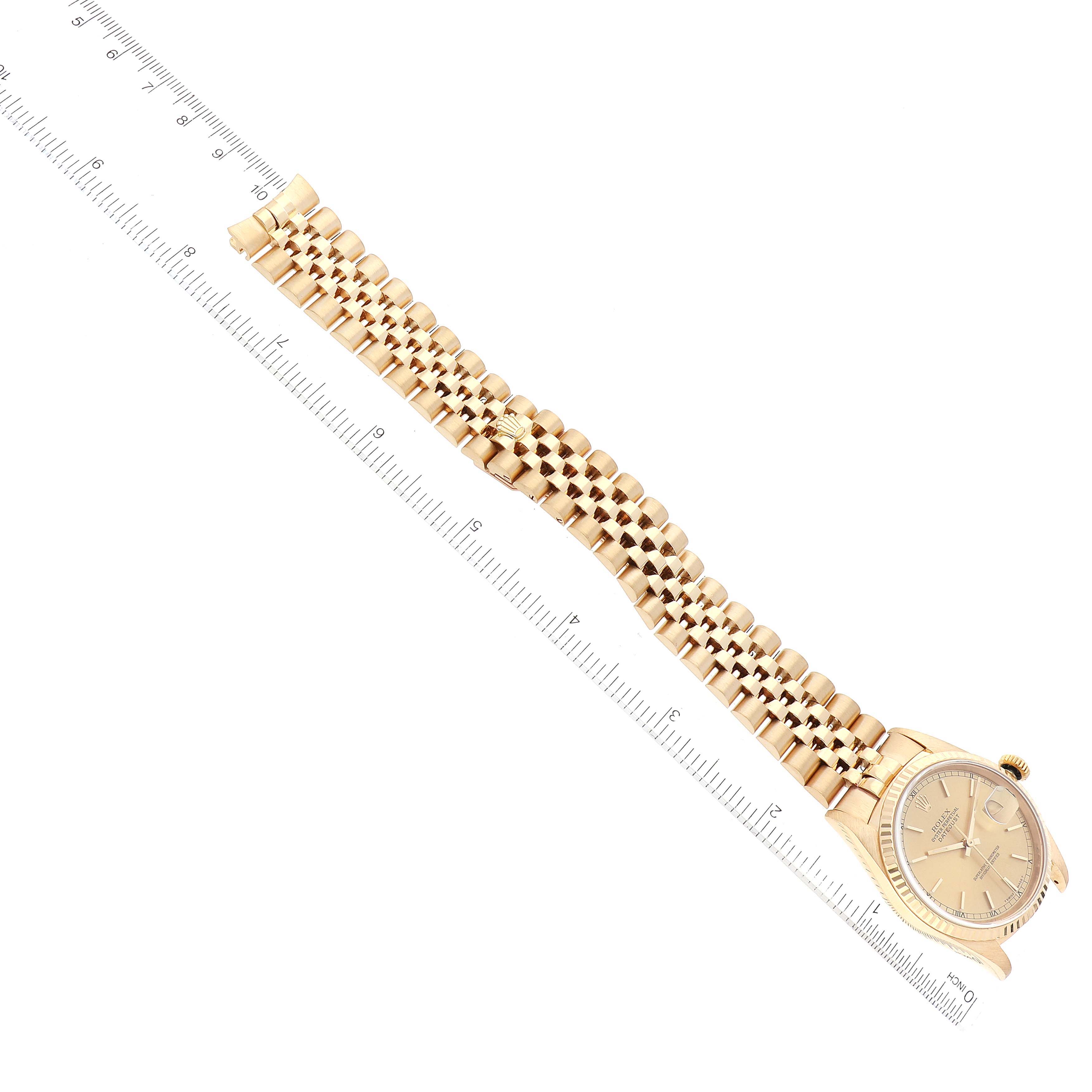 This image shows a Rolex President 16238 Men
s Yellow Gold Champagne Dial 16238 Men
s Yellow Gold Champagne Dial model watch aligned with a ruler, displaying the watch face and entire bracelet band.