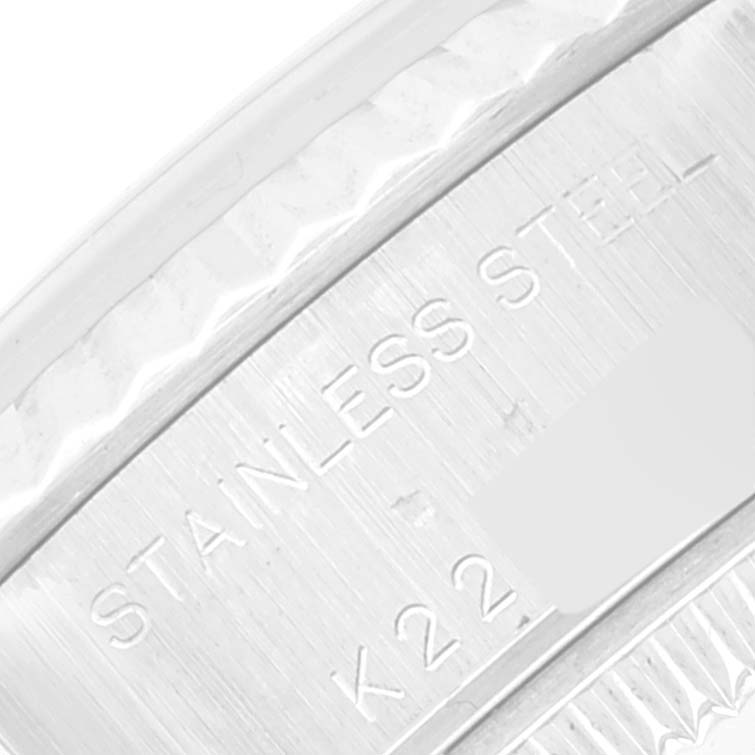 The image shows a close-up of the engraving on the caseback of a Rolex Datejust 79174 Women's Stainless Steel Silver Dial 79174 Women's Stainless Steel Silver Dial watch indicating "STAINLESS STEEL.”