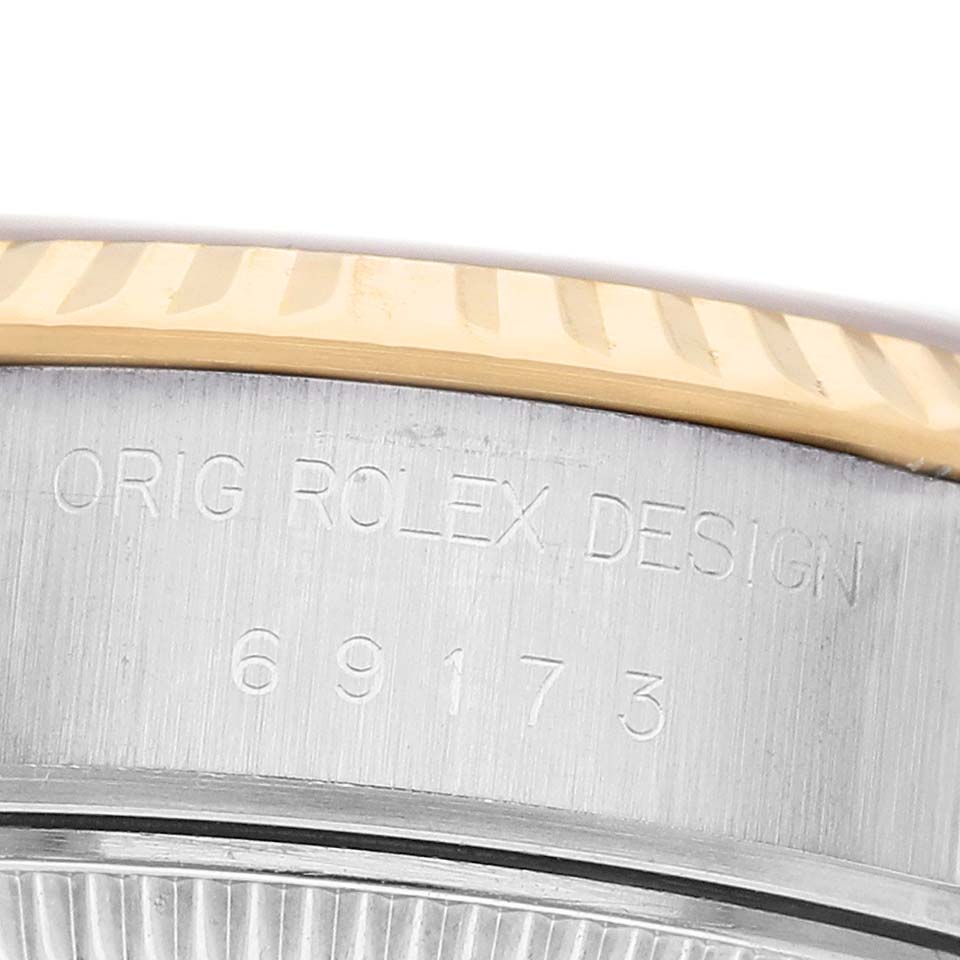 The image shows a close-up of the engraved side of a Rolex Datejust 69173 Women's Steel and Gold (two tone) Champagne Dial bezel and case, highlighting the model number.