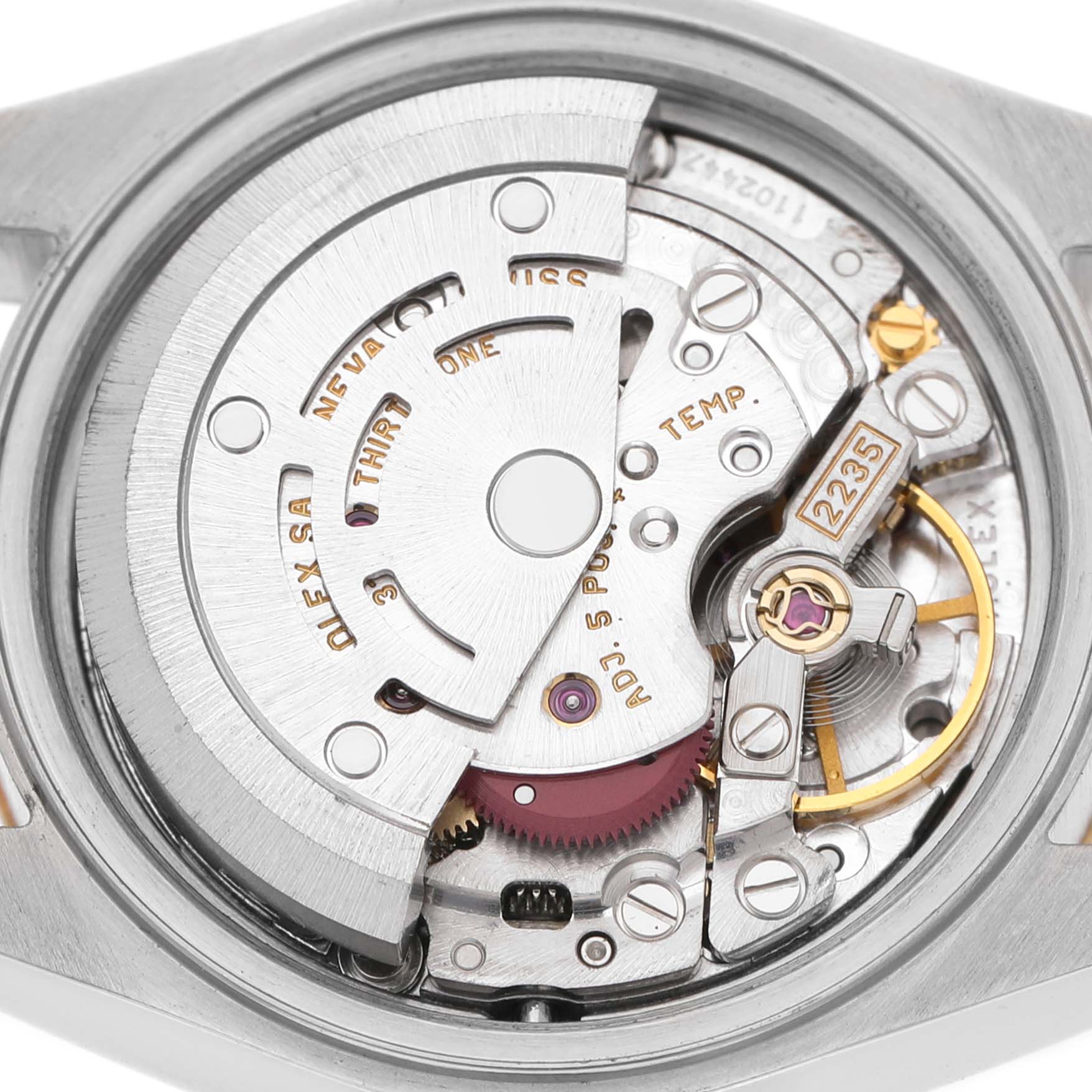 The image shows the movement of a Rolex Datejust 79173 Women's Steel and Gold (two tone) Champagne Dial watch, highlighting gears and intricate mechanical parts from the back.