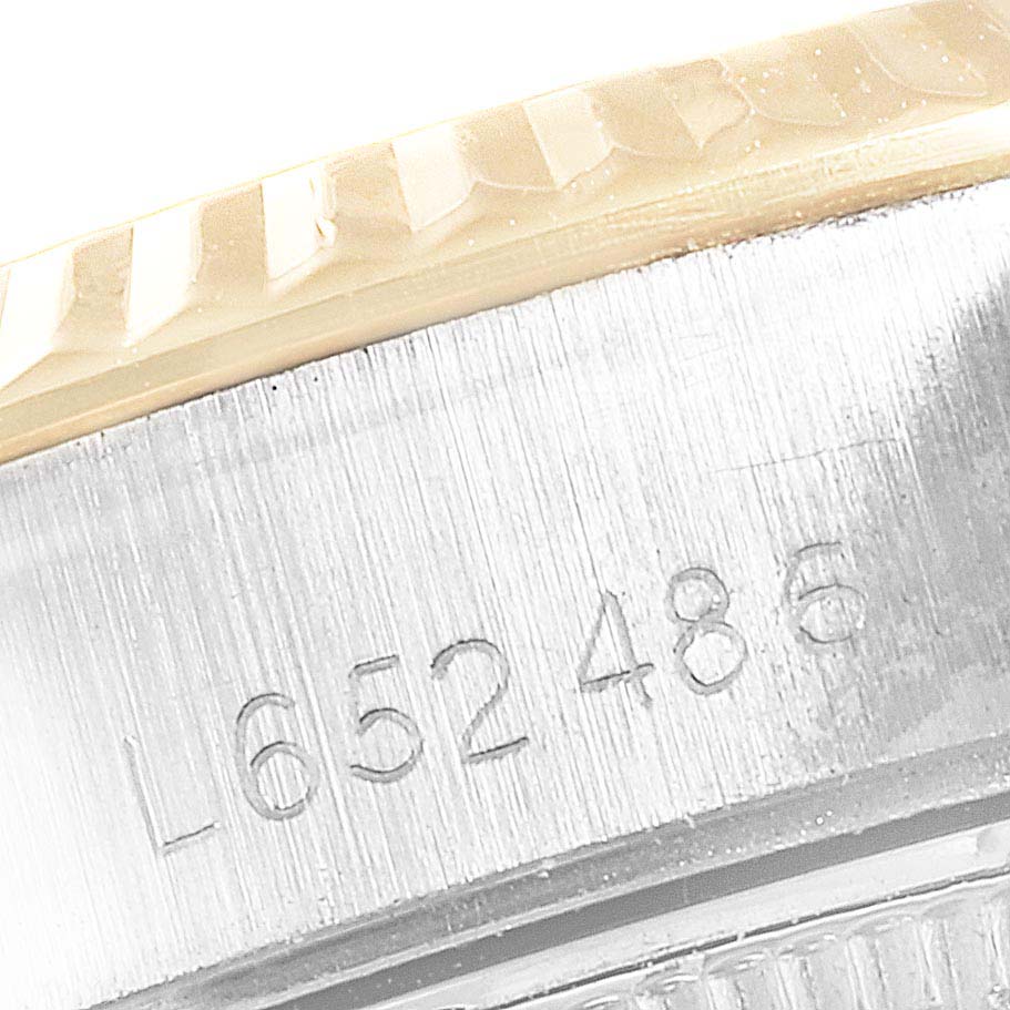 This image shows a close-up of the bezel, case, and serial number of a Rolex Datejust 69173 Women
s Steel and Gold (two tone) Champagne Dial 69173 Women
s Steel and Gold (two tone) Champagne Dial watch.