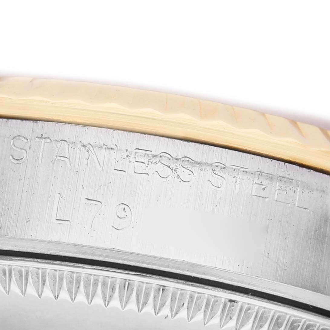 The image shows the side of a Rolex Mid-Size 68273 Women's Steel and Gold (two tone) White Dial watch, focusing on the engraved stainless steel part with the case edge.