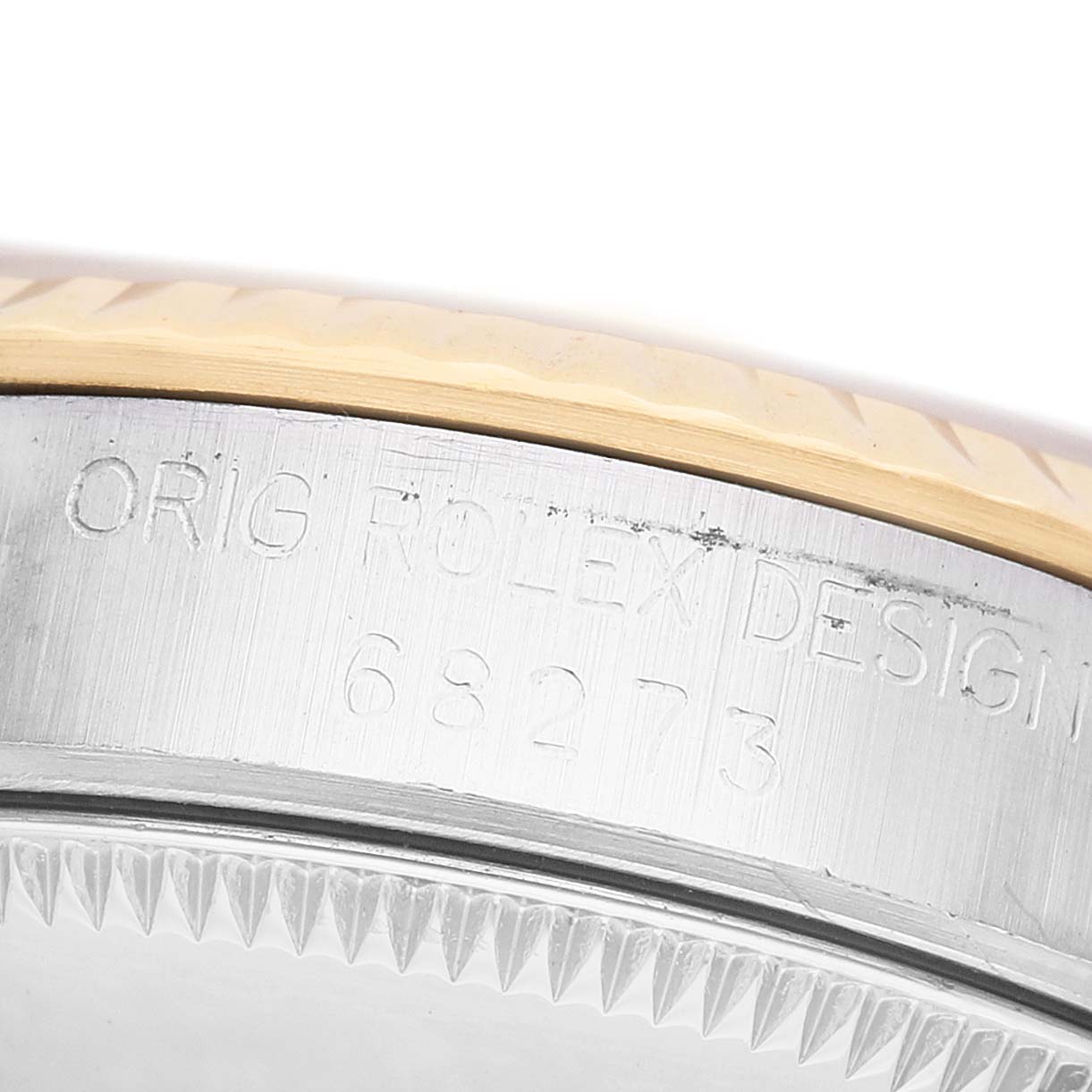 The image shows a close-up of the Mid-Size Rolex watch case with engravings.