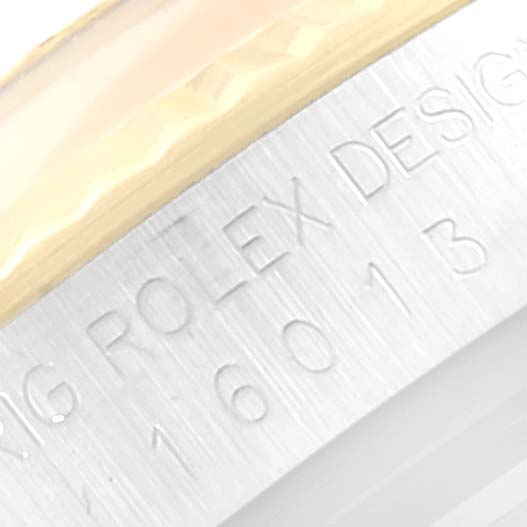 The image shows a close-up angle of the bezel and engraved lettering on the case of a Rolex Vintage Collection 16013 Men's Steel and Gold (two tone) Blue Dial 16013 Men's Steel and Gold (two tone) Blue Dial model.