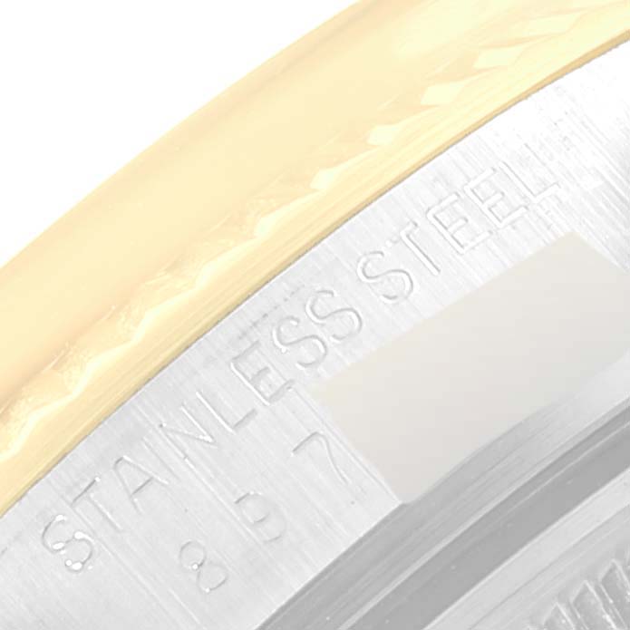 This is a close-up image of the edge and part of the case back of a Rolex Vintage Collection 16013 Men's Steel and Gold (two tone) Blue Dial 16013 Men's Steel and Gold (two tone) Blue Dial watch, showing an engraving.