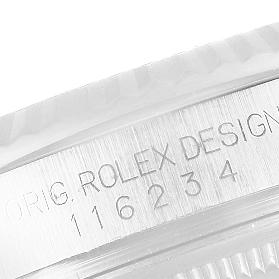 Close-up of the side view of a Rolex Datejust 116234 Men's Stainless Steel Mother of Pearl Dial 116234 Men's Stainless Steel Mother of Pearl Dial watch, showing the engraving "ORIG. ROLEX DESIGN 116234".