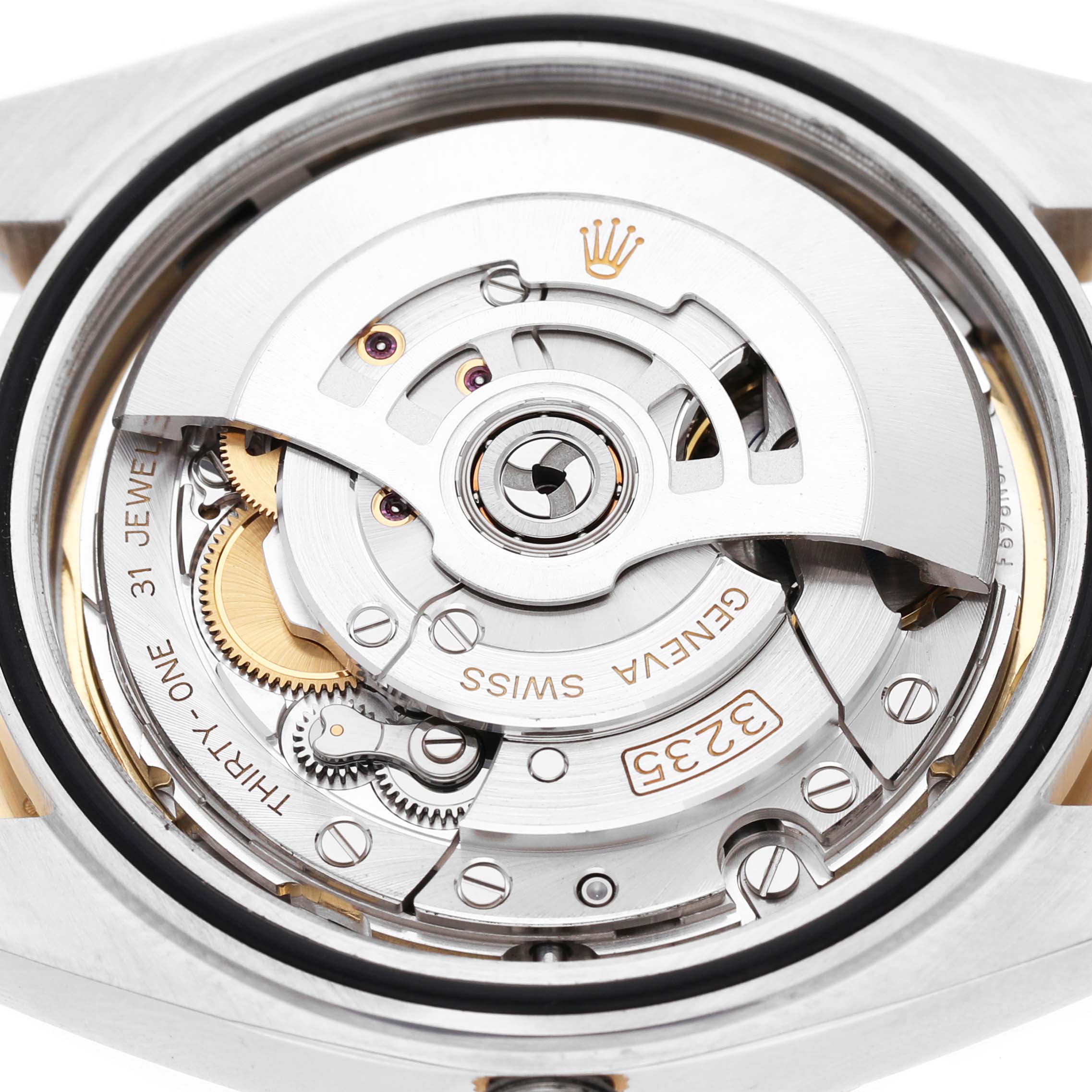 The image shows the inner mechanics of a Rolex Datejust 41 M126333-0011 Men's Steel and Gold (two tone) Champagne Dial, highlighting the movement and gears from the back angle.