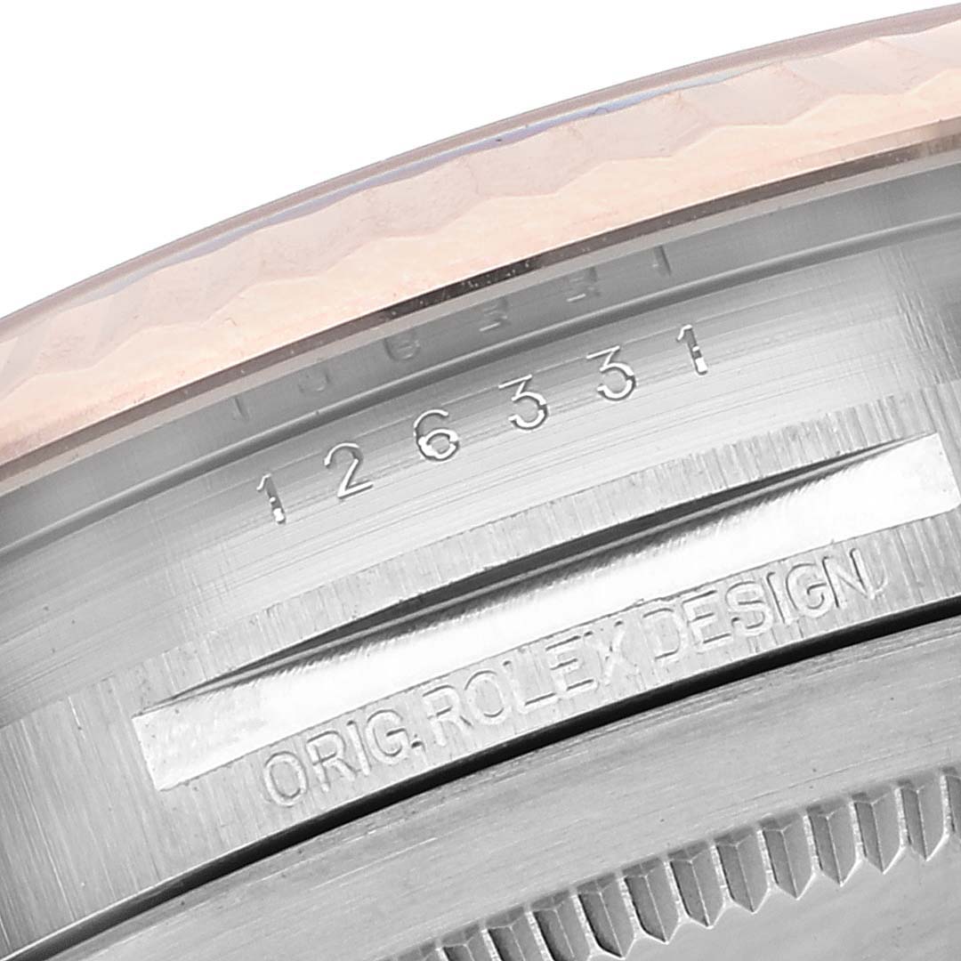 This close-up image shows the model and serial numbers engraved inside the bezel of a Rolex Datejust 41 126331 Men's Steel and Gold (two tone) Pink Dial 126331 Men's Steel and Gold (two tone) Pink Dial watch.