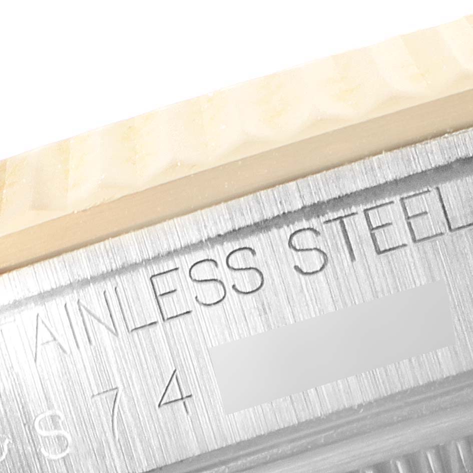 This image shows a close-up of the serial number and "STAINLESS STEEL" engraving on the side of a Rolex Datejust 16233 Men's Steel and Gold (two tone) Champagne Dial 16233 Men's Steel and Gold (two tone) Champagne Dial watch case.
