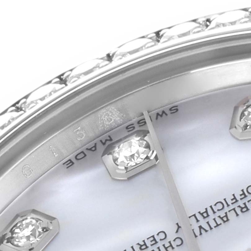 The image shows a close-up of a Rolex Mid-Size 178384 Women
s Stainless Steel Mother of Pearl Dial 178384 Women
s Stainless Steel Mother of Pearl Dial watch
s bezel and part of the diamond-set dial from an angled view.