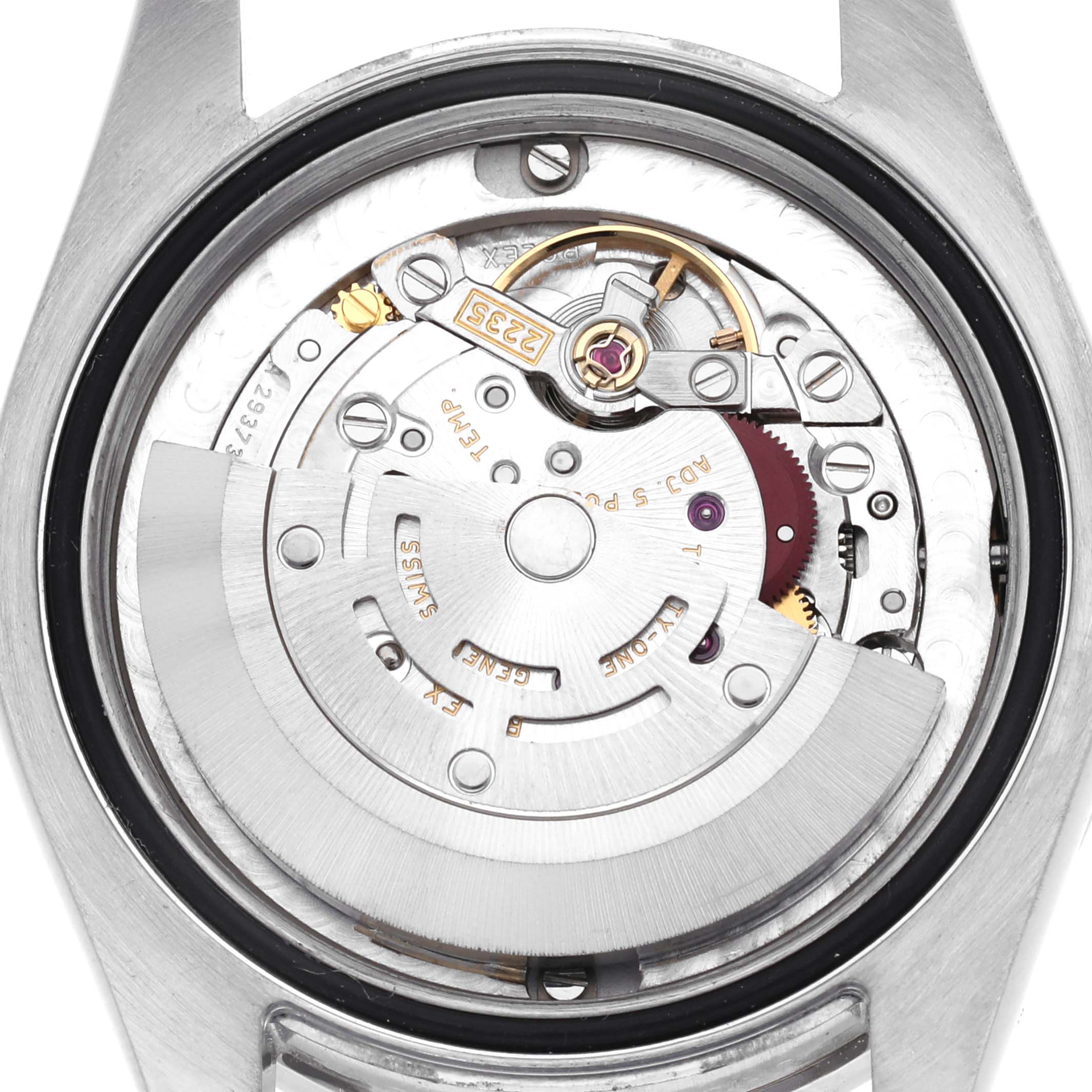 The image shows the back of a mid-size Rolex watch, revealing its internal movement mechanism.