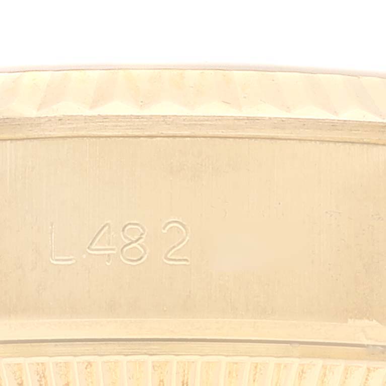 The image shows the engraved serial number on the inner side of the bezel of a Rolex President 69178 Women
s Yellow Gold Champagne Dial 69178 Women
s Yellow Gold Champagne Dial model watch.