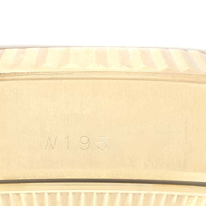 This image shows a close-up of the side of a Rolex President 69178 Women
s Yellow Gold Champagne Dial 69178 Women
s Yellow Gold Champagne Dial model watch, focusing on the bezel and part of the watch case with a serial number.