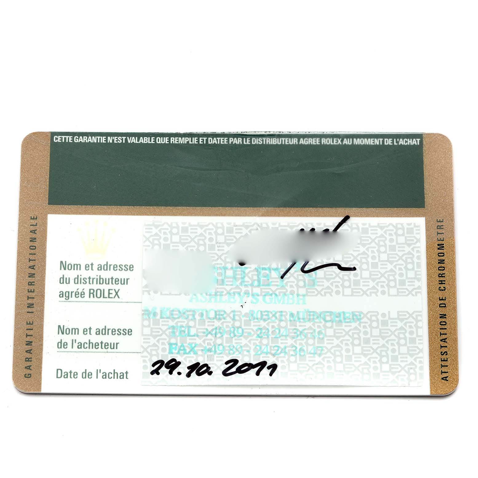 This image shows a warranty card for a mid-size Rolex watch, featuring text and date information.