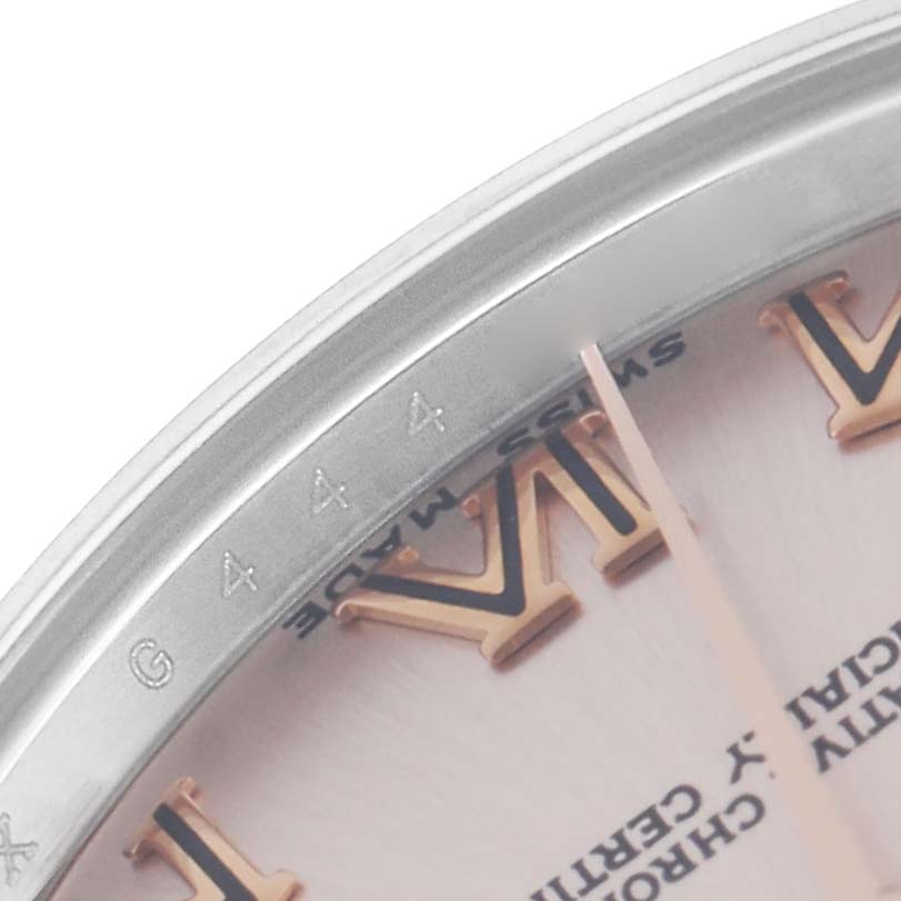 The image shows a close-up of the dial edge and bezel details of a Rolex Mid-Size 178271 Women
s Steel and Gold (two tone) Pink Dial 178271 Women
s Steel and Gold (two tone) Pink Dial watch, focusing on the Roman numeral markers.