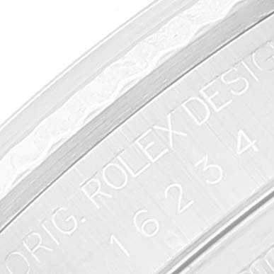 This is a close-up image of the case of a Rolex Datejust 16234 Men
s Stainless Steel Black Dial 16234 Men
s Stainless Steel Black Dial watch, showing engraved text and design numbers.