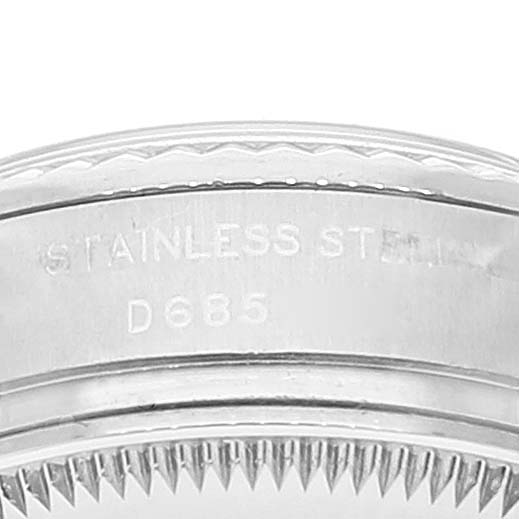 Close-up of the edge and bezel of a Rolex Datejust 179174 Women
s Stainless Steel Mother of Pearl Dial 179174 Women
s Stainless Steel Mother of Pearl Dial, showing engraved text and stainless steel detailing.