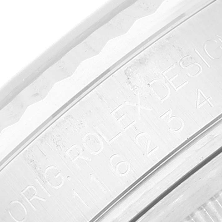 This is a close-up image of the case and bezel, showing the engraved serial number of a Rolex Datejust 116234 Men's Stainless Steel White Dial 116234 Men's Stainless Steel White Dial model watch.