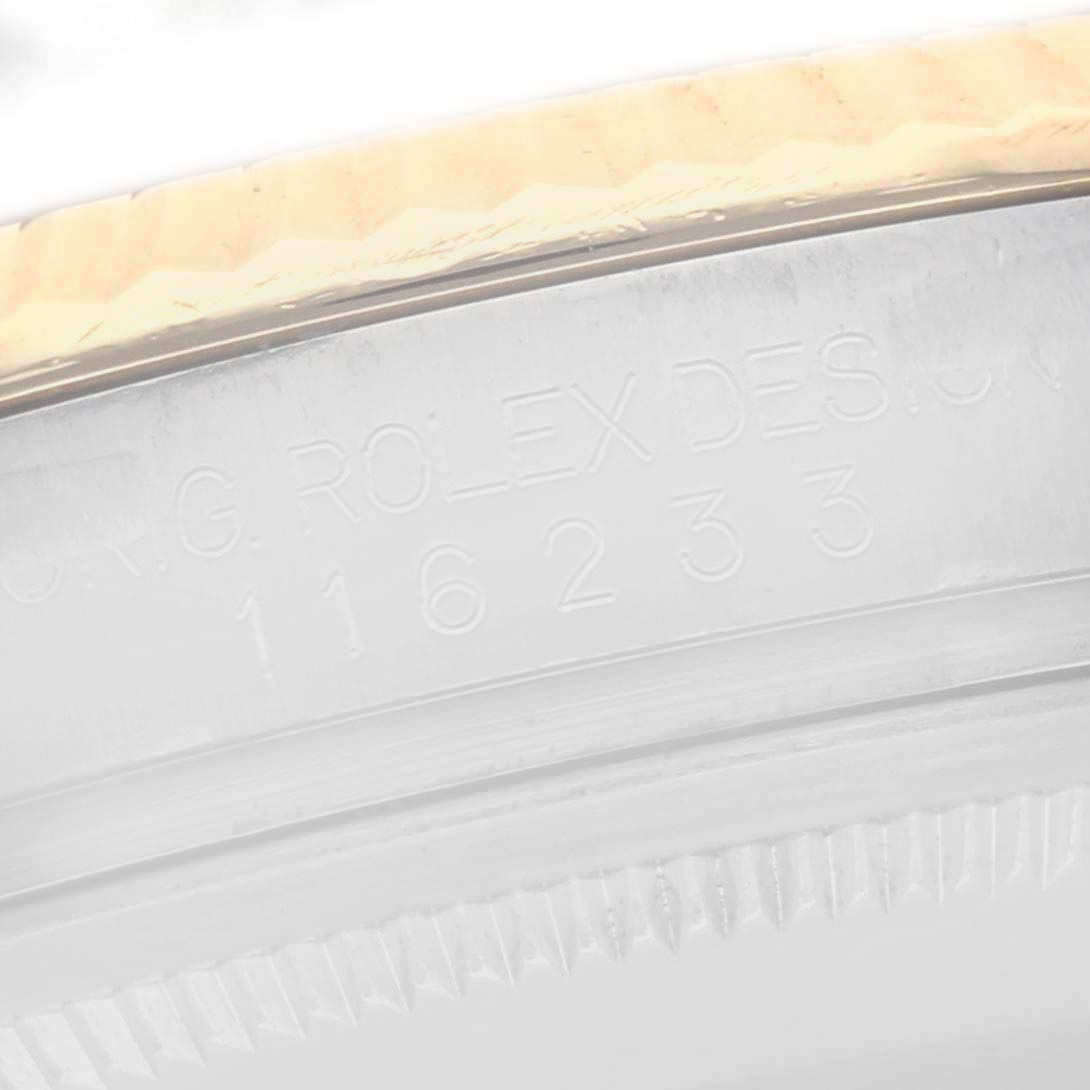 The image shows a close-up of the side of a Rolex Datejust 116233 Men
s Steel and Gold (two tone) Champagne Dial 116233 Men
s Steel and Gold (two tone) Champagne Dial watch case, highlighting the engraved serial and model numbers.