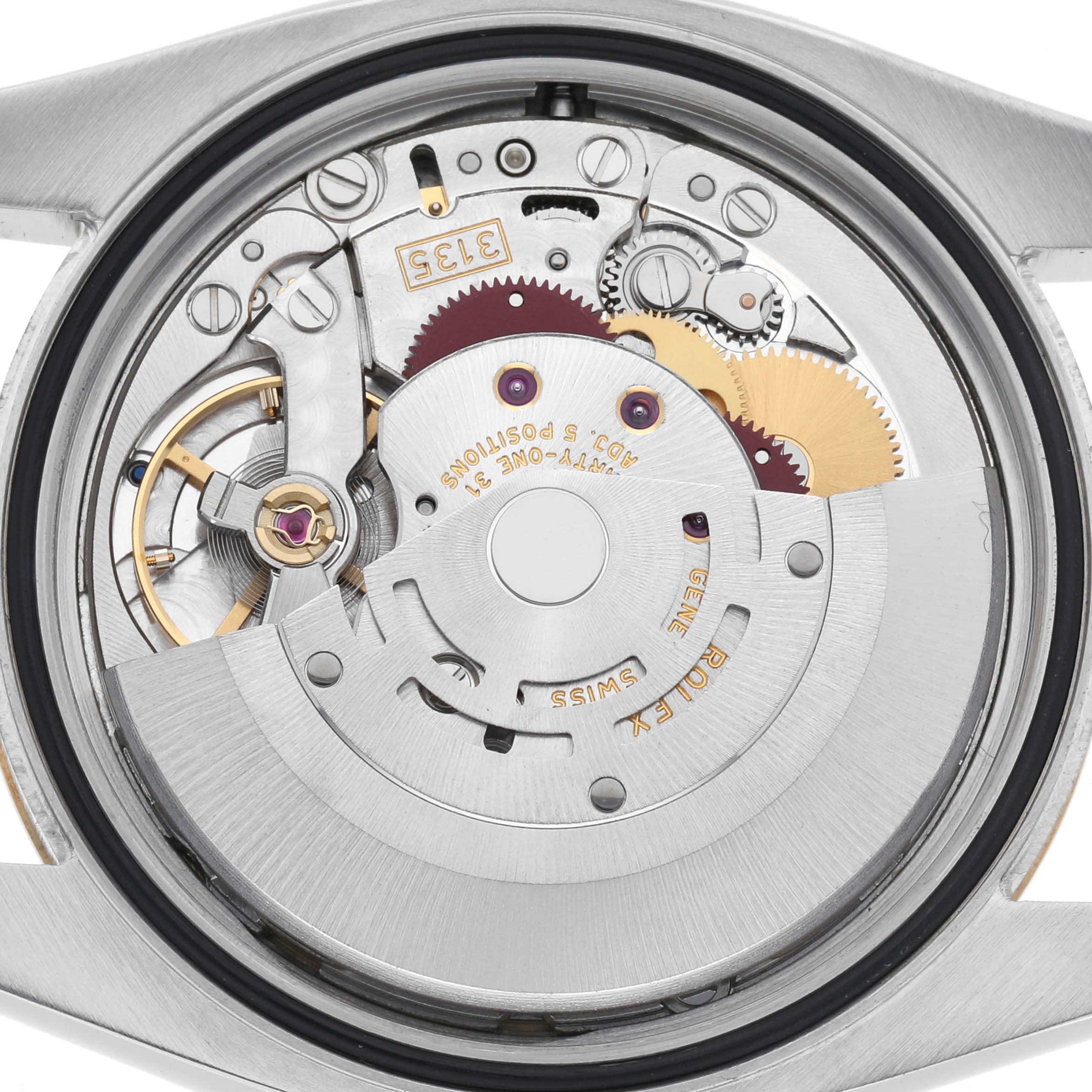 The image shows the movement mechanism of a Rolex Datejust 116233 Men
s Steel and Gold (two tone) Champagne Dial 116233 Men
s Steel and Gold (two tone) Champagne Dial watch from the back, highlighting gears and rotors.