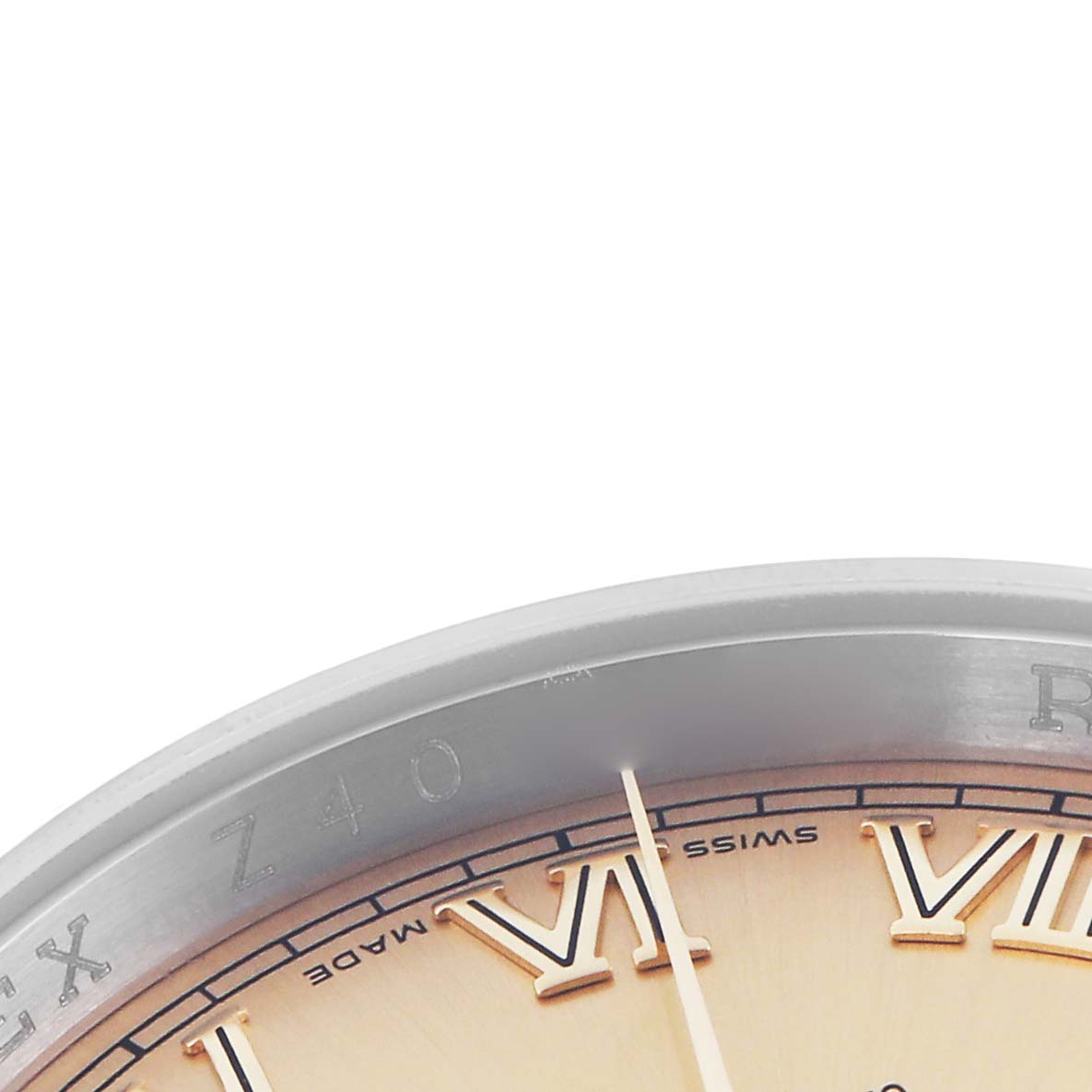 The image shows a close-up of the Rolex Datejust 116233 Men
s Steel and Gold (two tone) Champagne Dial 116233 Men
s Steel and Gold (two tone) Champagne Dial watch
s edge, bezel, dial, and part of the Roman numeral markers.