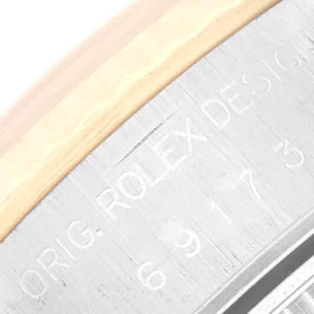 This image shows a close-up of the edge of the caseback of a Rolex Datejust 69173 Women's Steel and Gold (two tone) Champagne Dial 69173 Women's Steel and Gold (two tone) Champagne Dial watch.
