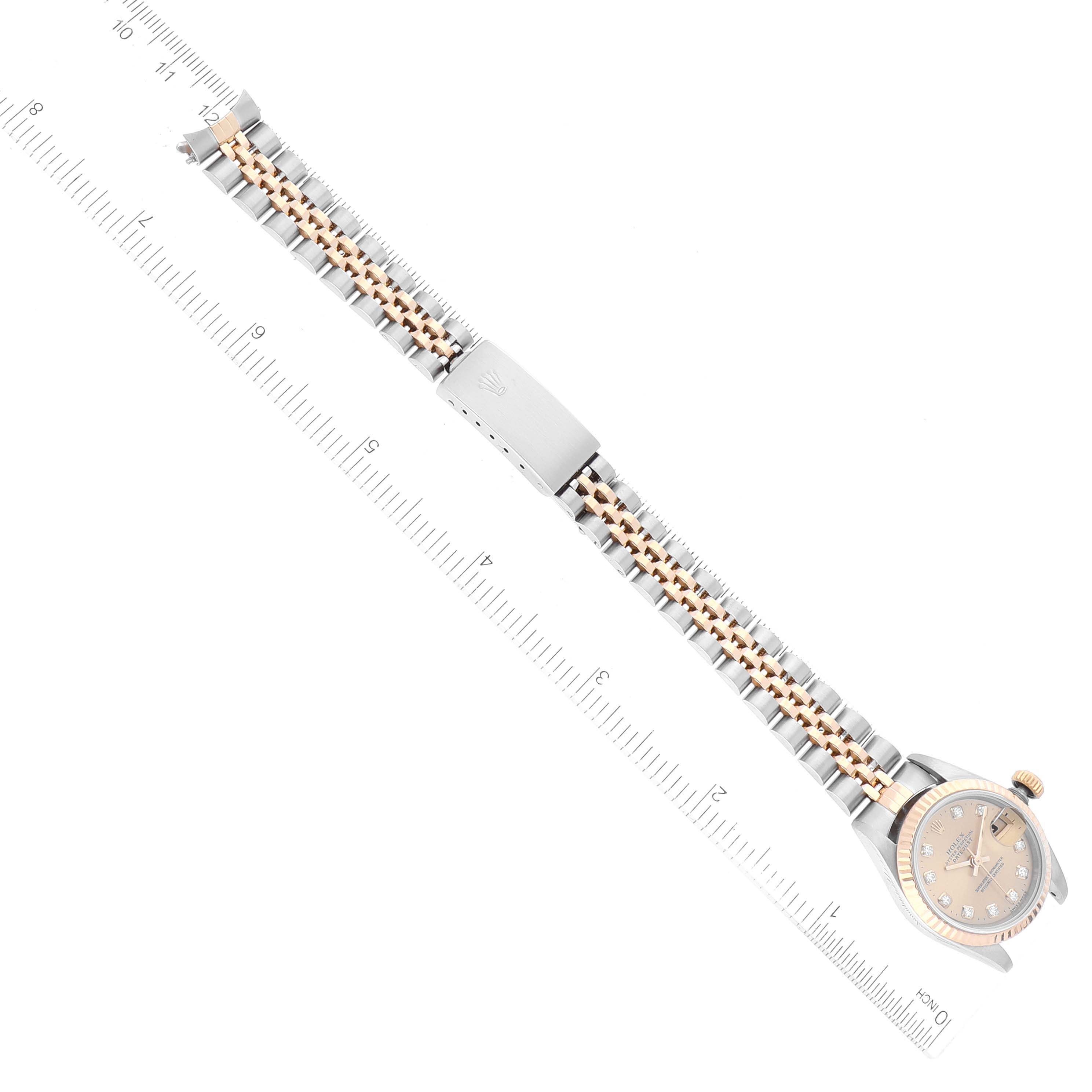The Rolex Datejust 69173 Women's Steel and Gold (two tone) Champagne Dial 69173 Women's Steel and Gold (two tone) Champagne Dial watch is shown from an overhead view, featuring the bracelet and clasp laid flat with a ruler for scale.