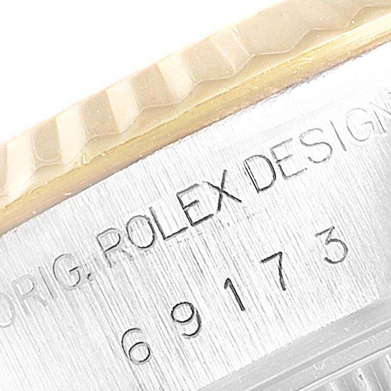 The image shows a close-up of the engraved side of the Rolex Datejust 69173  Women
s Steel and Gold (two tone) Champagne Dial 69173  Women
s Steel and Gold (two tone) Champagne Dial watch case, featuring the branding and model number.