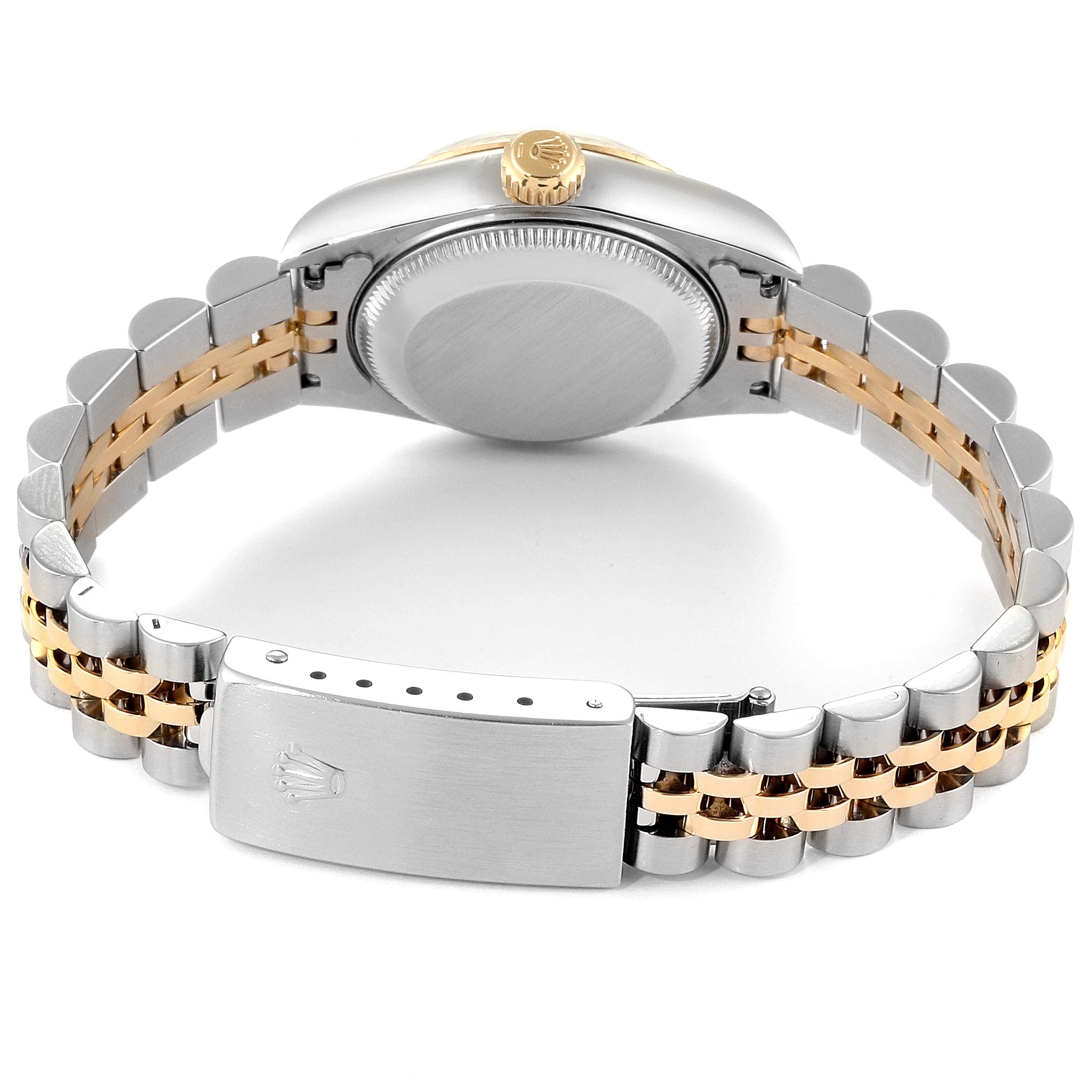 This image shows the backside of a Rolex Datejust 69173  Women
s Steel and Gold (two tone) Champagne Dial 69173  Women
s Steel and Gold (two tone) Champagne Dial watch, highlighting its clasp, bracelet, case back, crown, and bracelet.