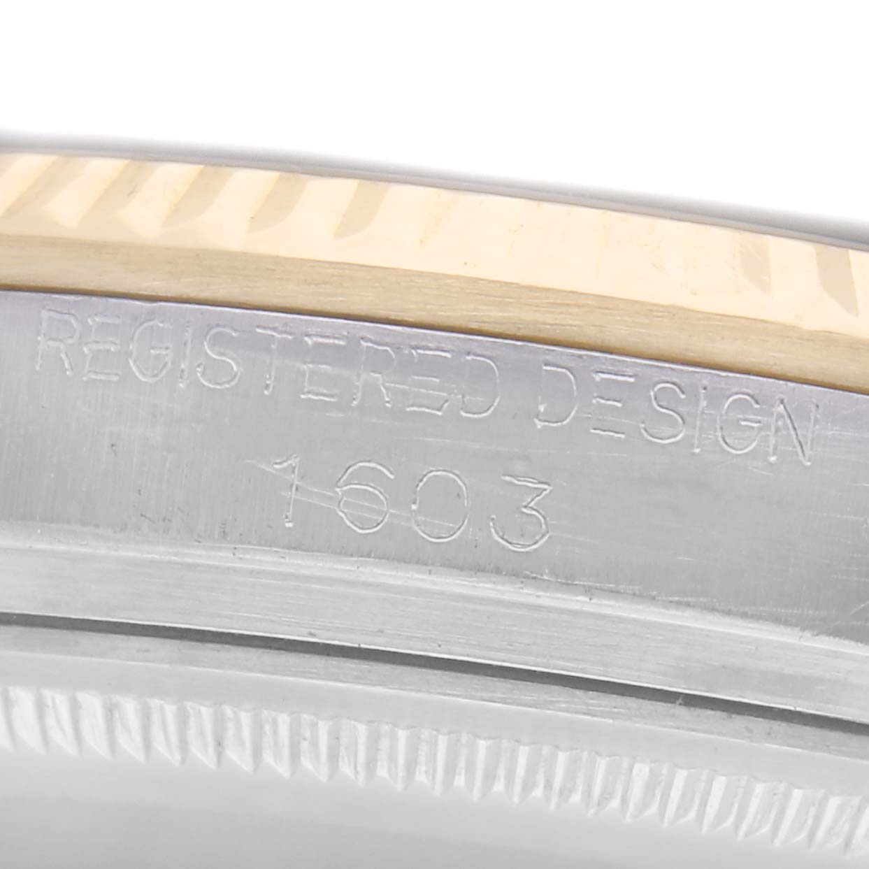 The image shows a close-up of the side of a Rolex Datejust 1603 Men
s Steel and Gold (two tone) Champagne Dial 1603 Men
s Steel and Gold (two tone) Champagne Dial, focusing on the engraved model number.