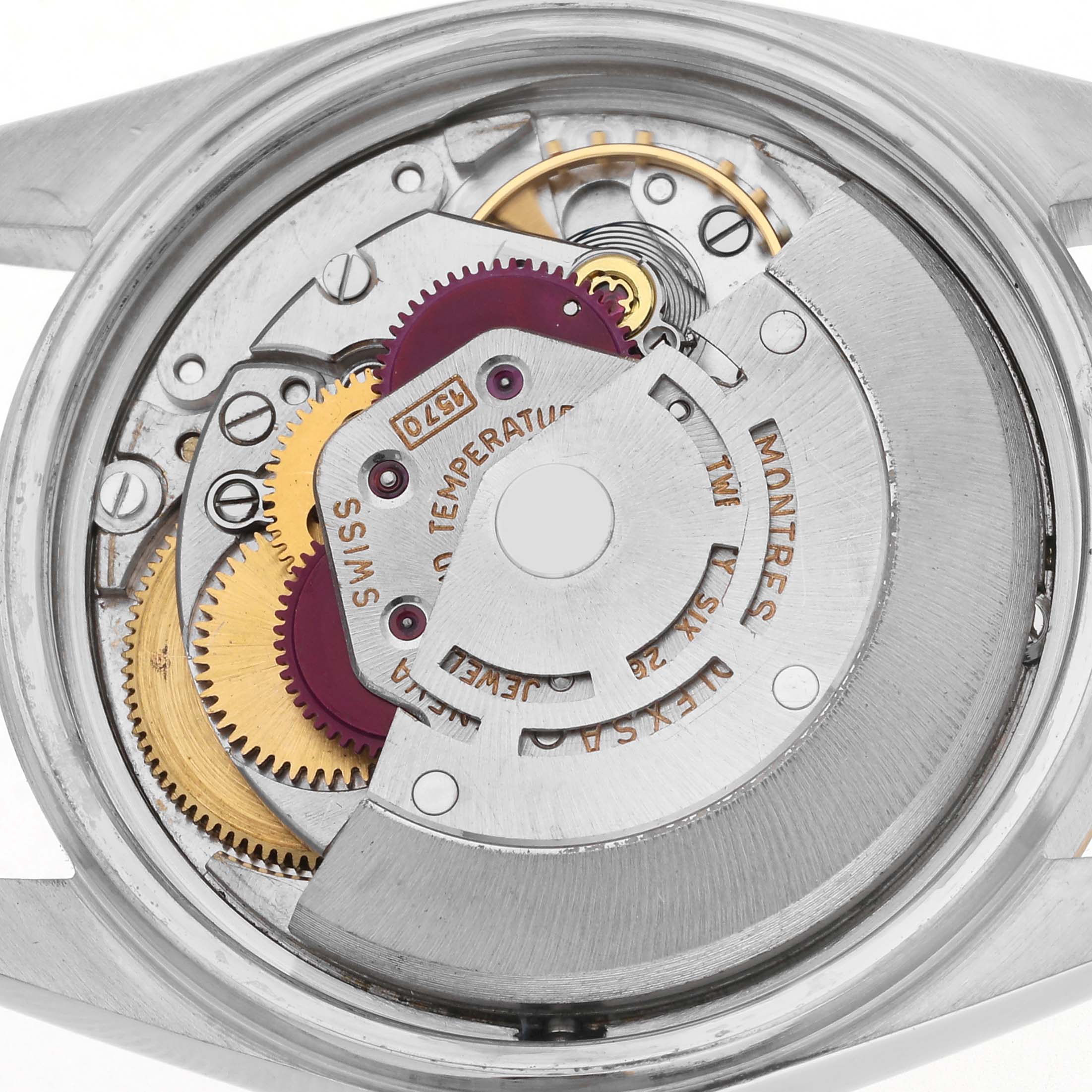 The image shows the movement of a Rolex Datejust 1603 Men
s Steel and Gold (two tone) Champagne Dial 1603 Men
s Steel and Gold (two tone) Champagne Dial watch from a rear angle, highlighting gears and the rotor.