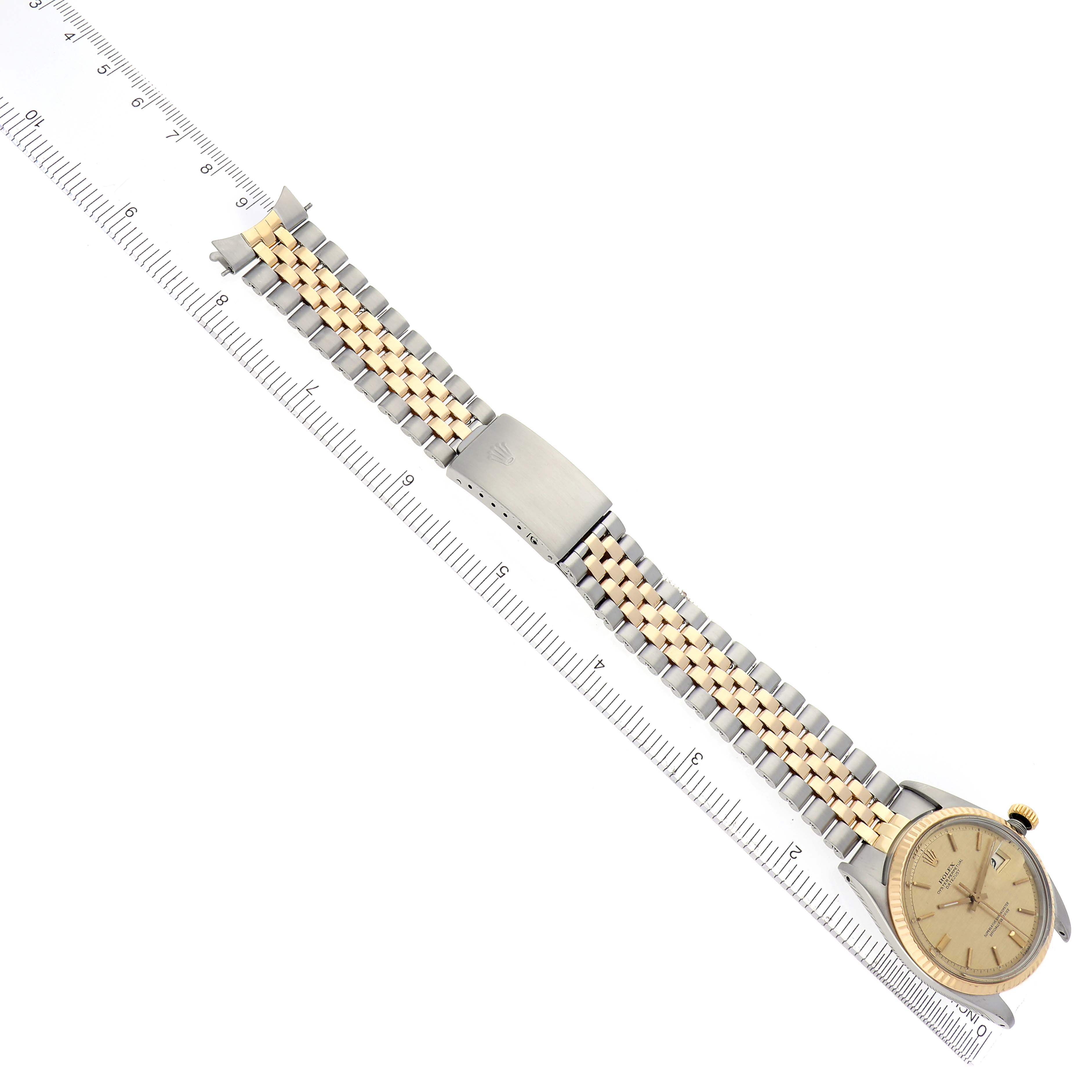 The Rolex Datejust 1603 Men
s Steel and Gold (two tone) Champagne Dial 1603 Men
s Steel and Gold (two tone) Champagne Dial watch is shown from an overhead angle, displaying the dial, bezel, two-tone bracelet, and clasp.