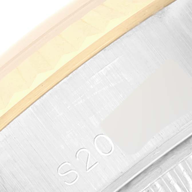 This close-up image shows a portion of the bezel and case side of a Rolex Datejust 69173 Women's Steel and Gold (two tone) White Dial 69173 Women's Steel and Gold (two tone) White Dial watch.