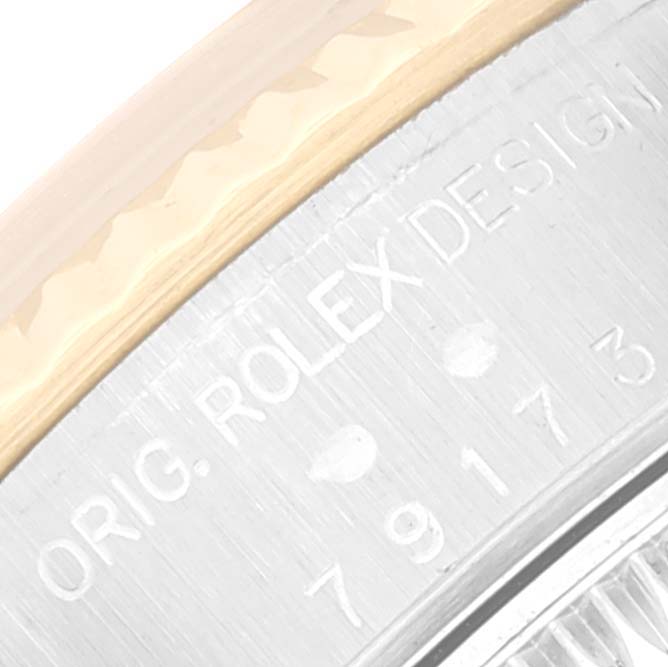 The image shows a close-up of the casing edge and engravings on a Rolex Datejust 79173 Women's Stainless Steel Silver Dial 79173 Women's Stainless Steel Silver Dial watch bezel.