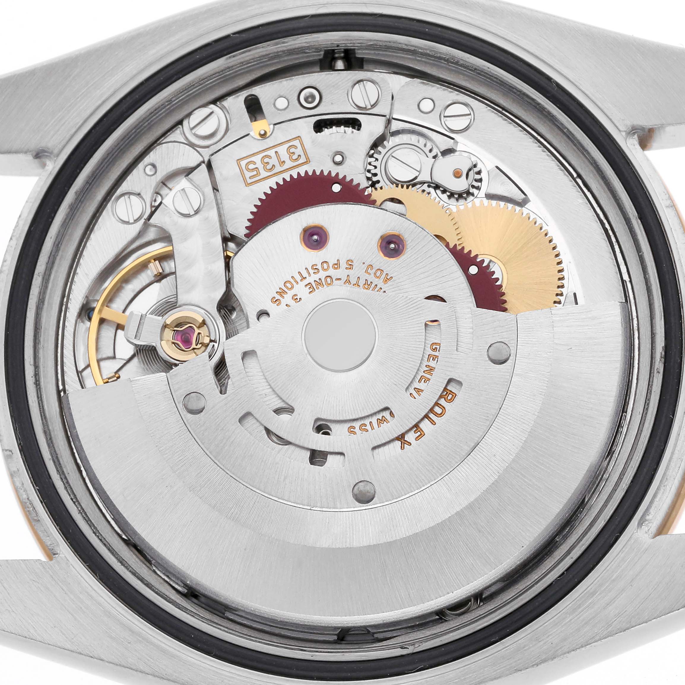 The image shows the movement mechanism of a Rolex Turn-o-Graph 116261 Men
s Steel and Gold (two tone) Silver Dial 116261 Men
s Steel and Gold (two tone) Silver Dial watch from a rear perspective, highlighting gears and components.