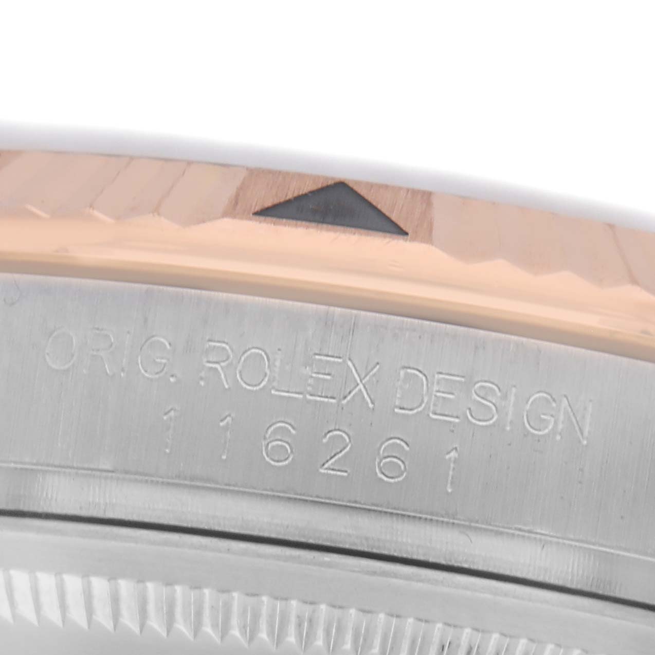 The image shows a partial view of the bezel and case side of the Rolex Turn-o-Graph 116261 Men
s Steel and Gold (two tone) Silver Dial 116261 Men
s Steel and Gold (two tone) Silver Dial, highlighting the engraving and a triangular marker.