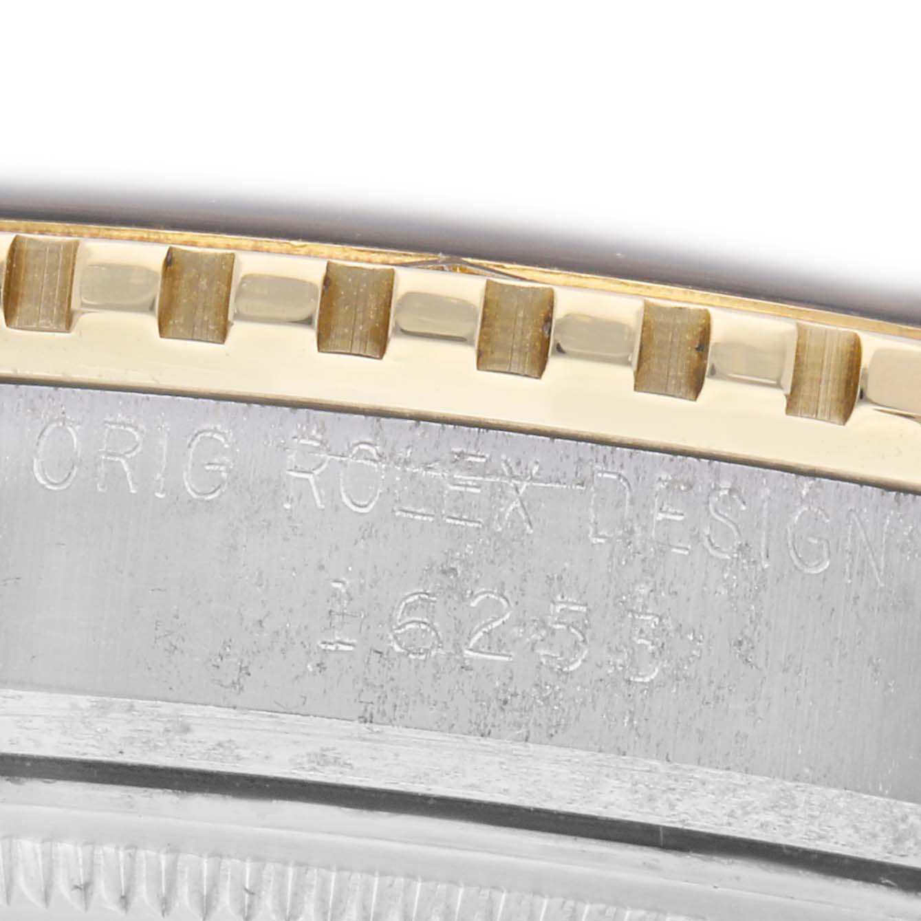 The image shows a close-up of the bezel and engraved edge of a Rolex Turn-o-Graph 16253 Men
s Steel and Gold (two tone) Blue Dial 16253 Men
s Steel and Gold (two tone) Blue Dial watch.