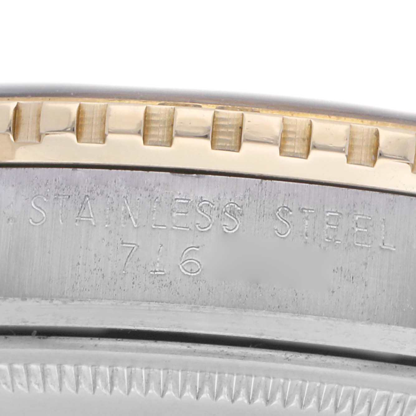 The image shows a close-up of the bezel and engraved side of the Rolex Turn-o-Graph 16253 Men
s Steel and Gold (two tone) Blue Dial 16253 Men
s Steel and Gold (two tone) Blue Dial, highlighting its stainless steel and gold details.