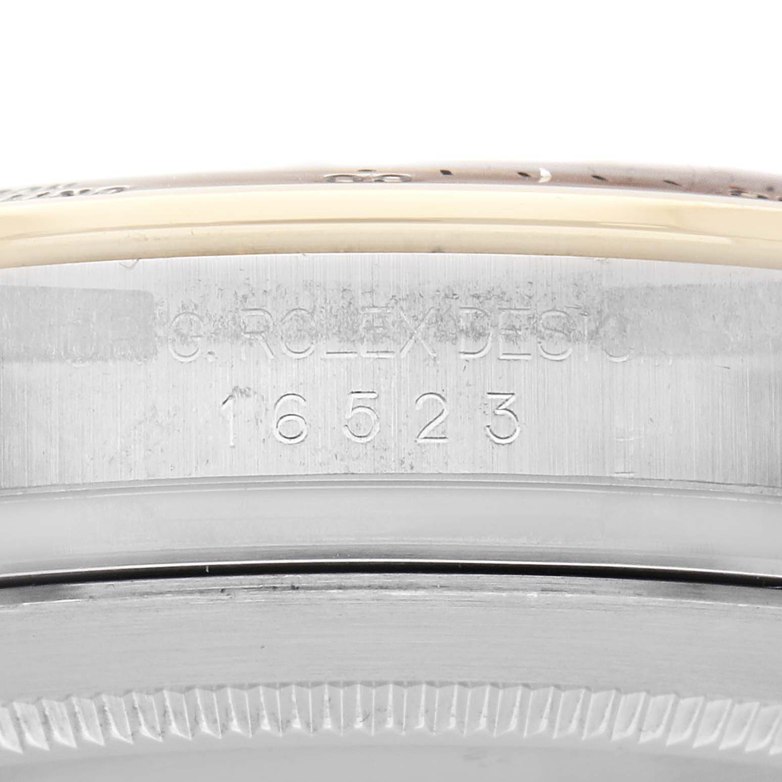 The image shows the side view of the Rolex Daytona 16523 Men
s Steel and Gold (two tone) White Dial 16523 Men
s Steel and Gold (two tone) White Dial, highlighting the model number engraving on its case.