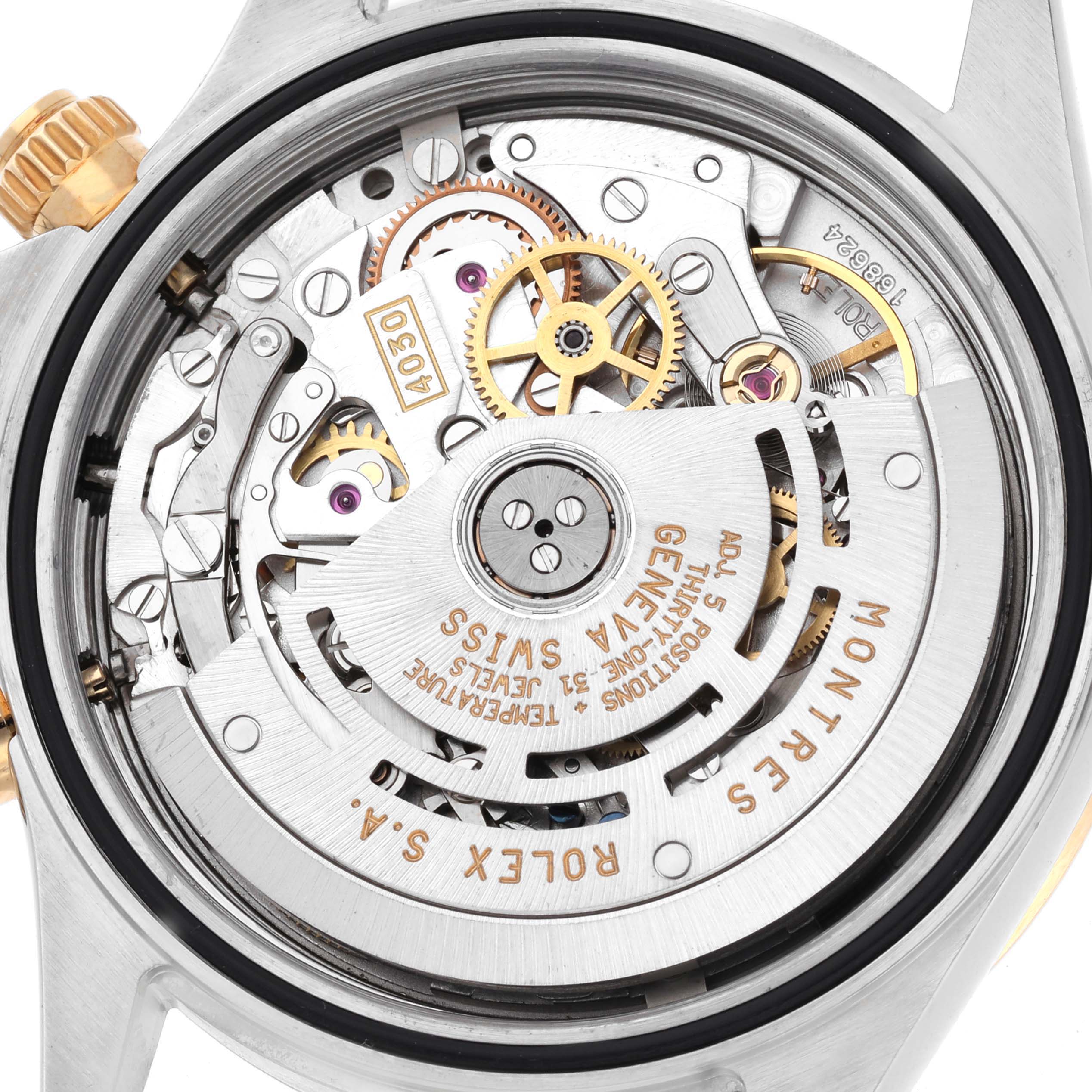 The image shows the Rolex Daytona 16523 Men
s Steel and Gold (two tone) White Dial 16523 Men
s Steel and Gold (two tone) White Dial
s movement from the back, highlighting gears and intricate mechanical parts.