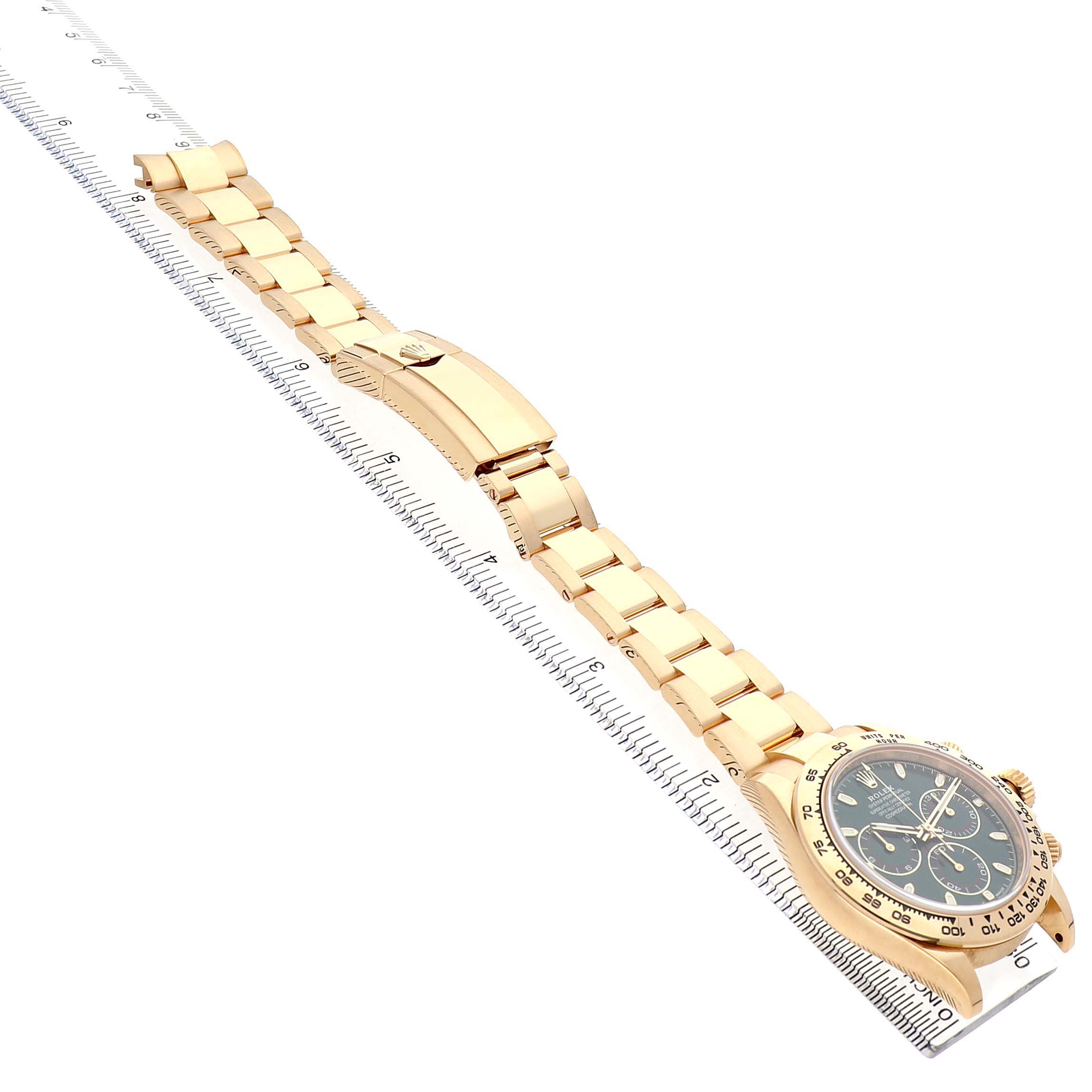 The image shows a Rolex Daytona 116508 Mens Yellow Gold Green Dial watch from a side angle, displaying the band, clasp, and face aligned along a ruler.