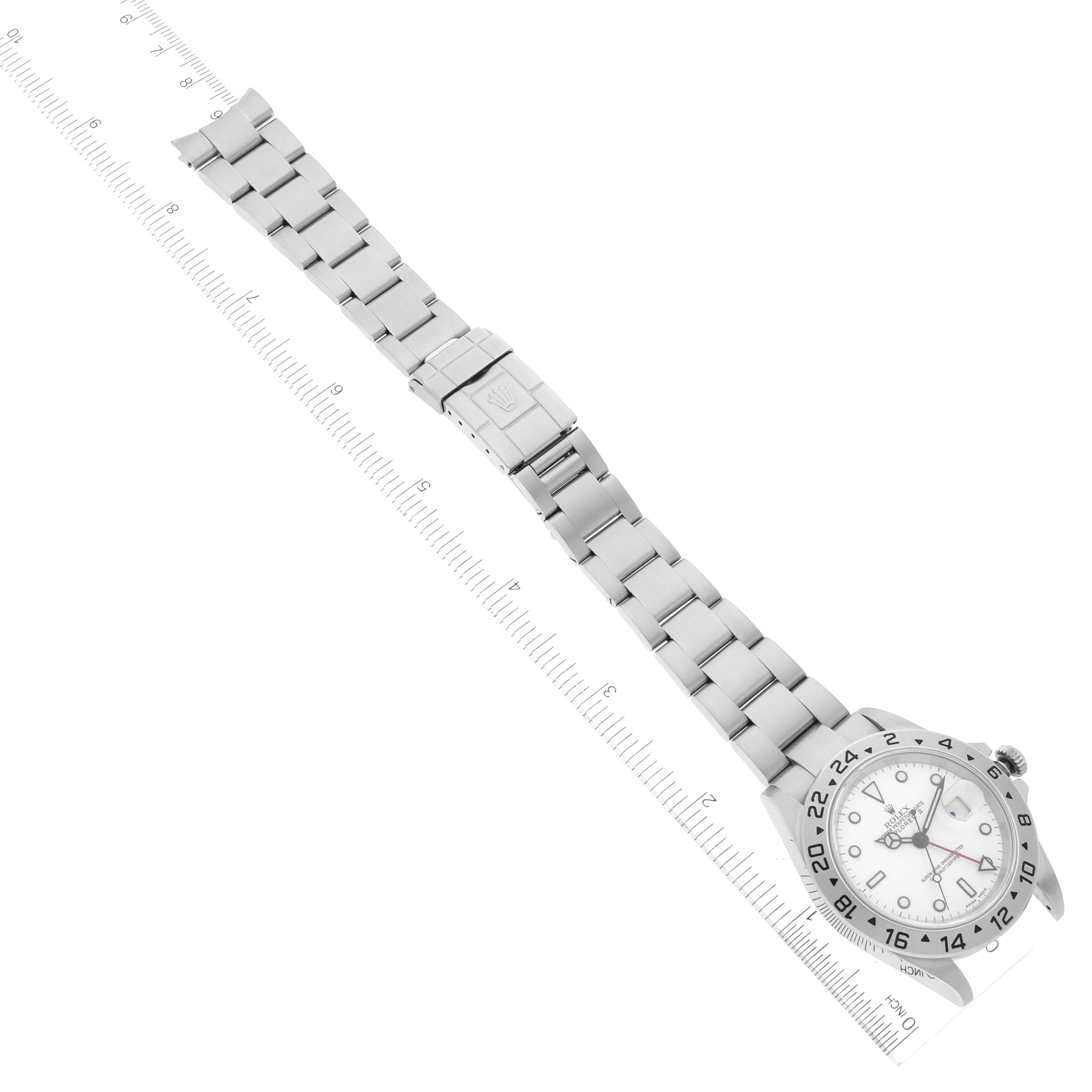 This image shows a Rolex Explorer 16570 Men's Stainless Steel White Dial 16570 Men's Stainless Steel White Dial watch laid flat, displaying the entire bracelet, clasp, case, bezel, and dial, alongside a ruler.