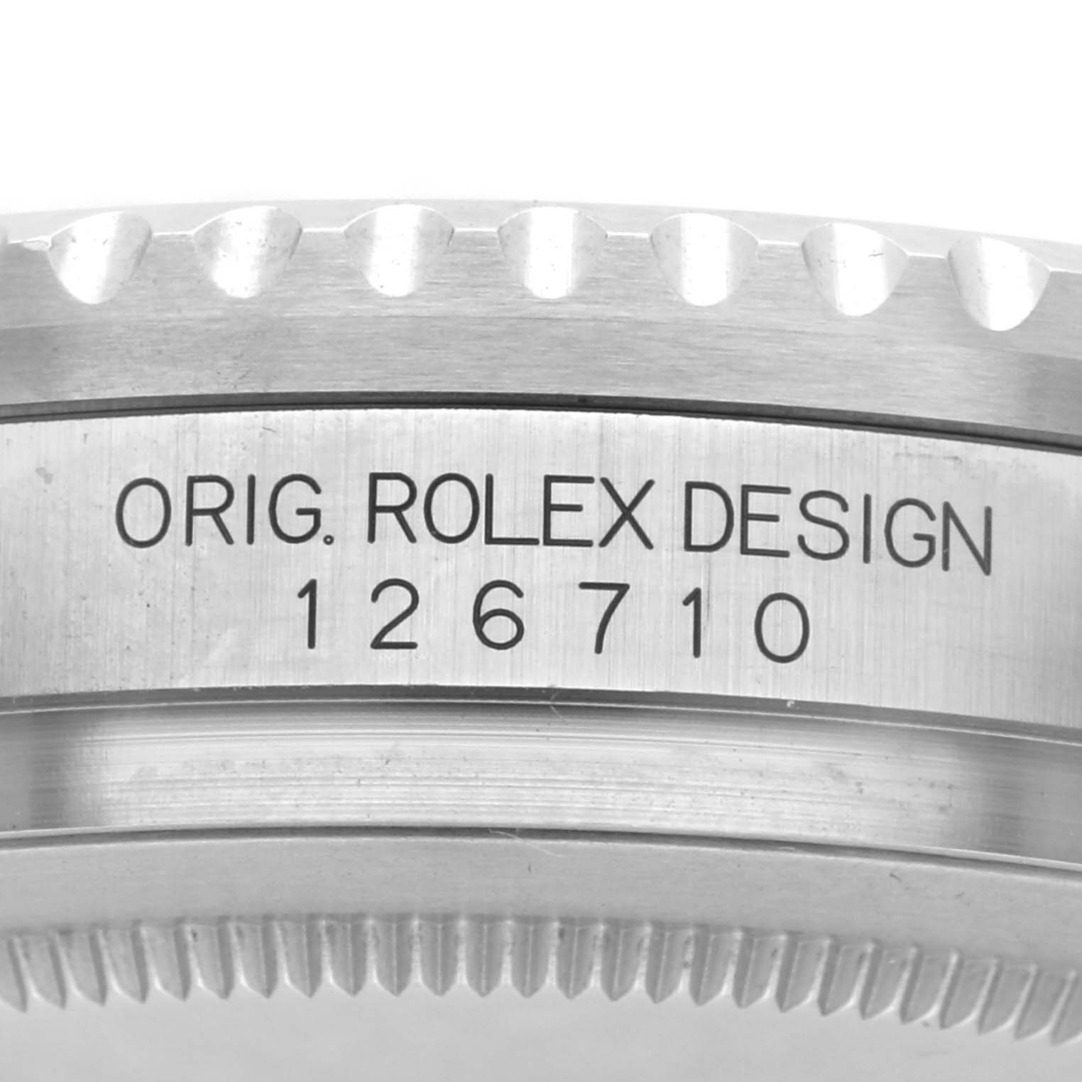 The image shows a close-up of the side of a Rolex GMT-Master 126710 Men
s Stainless Steel Black Dial 126710 Men
s Stainless Steel Black Dial, displaying the case with engraved design details.